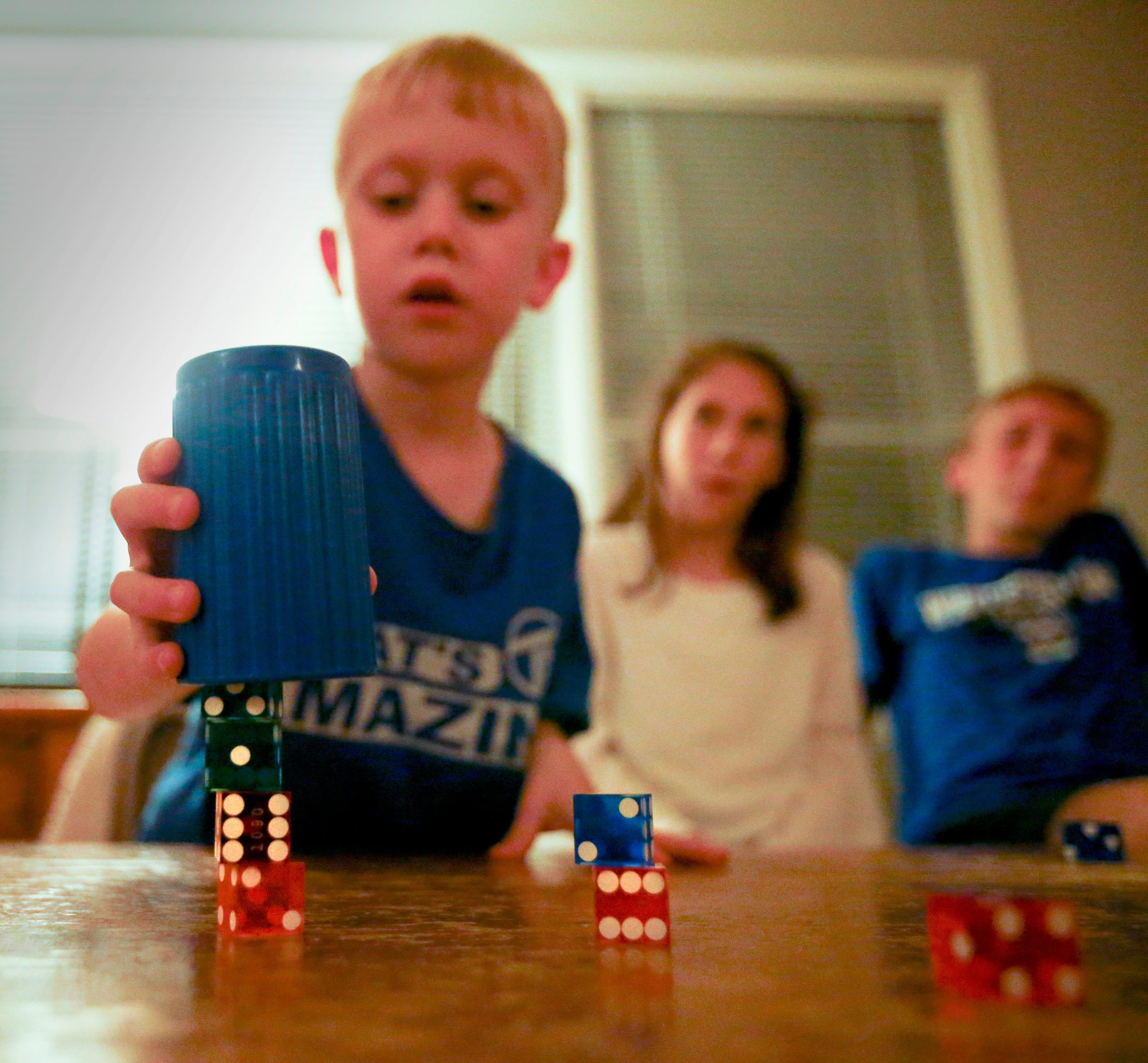 Colin End, 5, demonstrates his dice stacking skills in the family