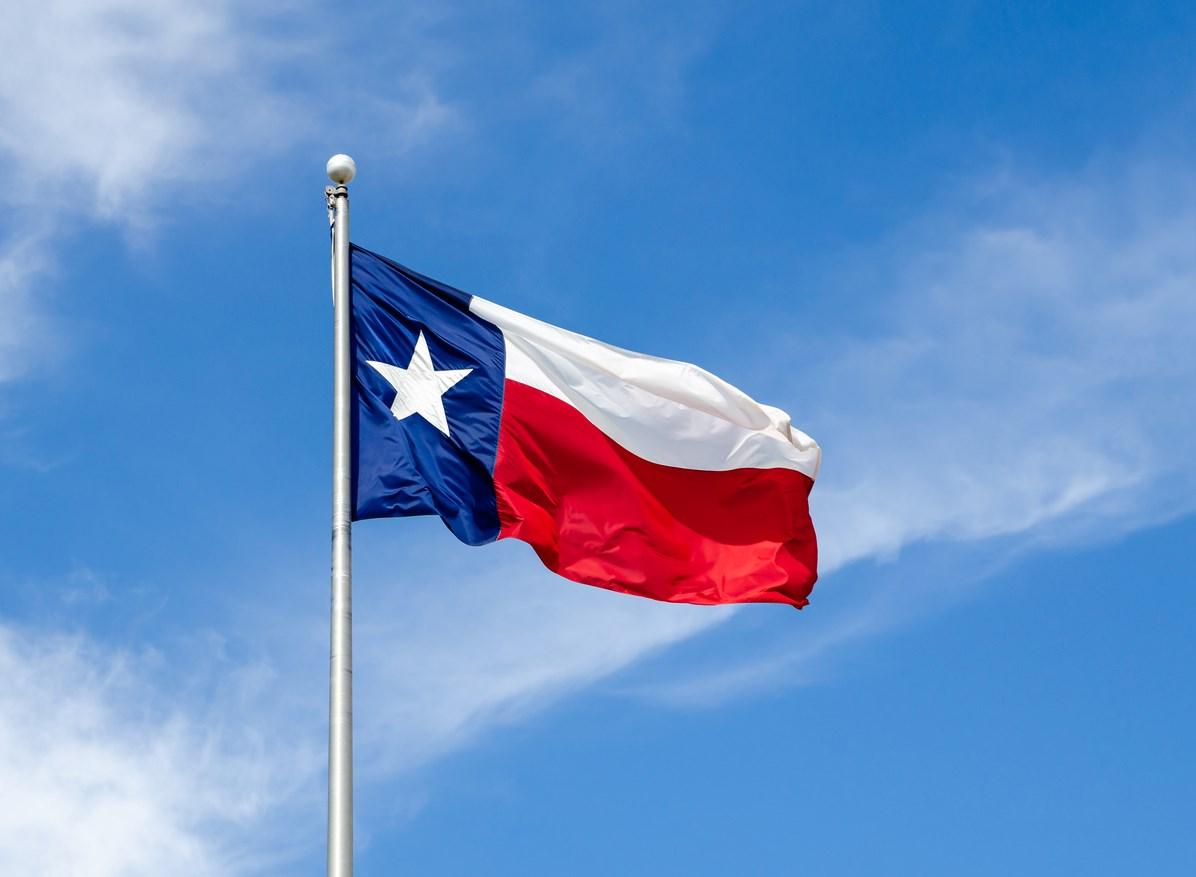Texas state flag waving in the air from its flagpole.