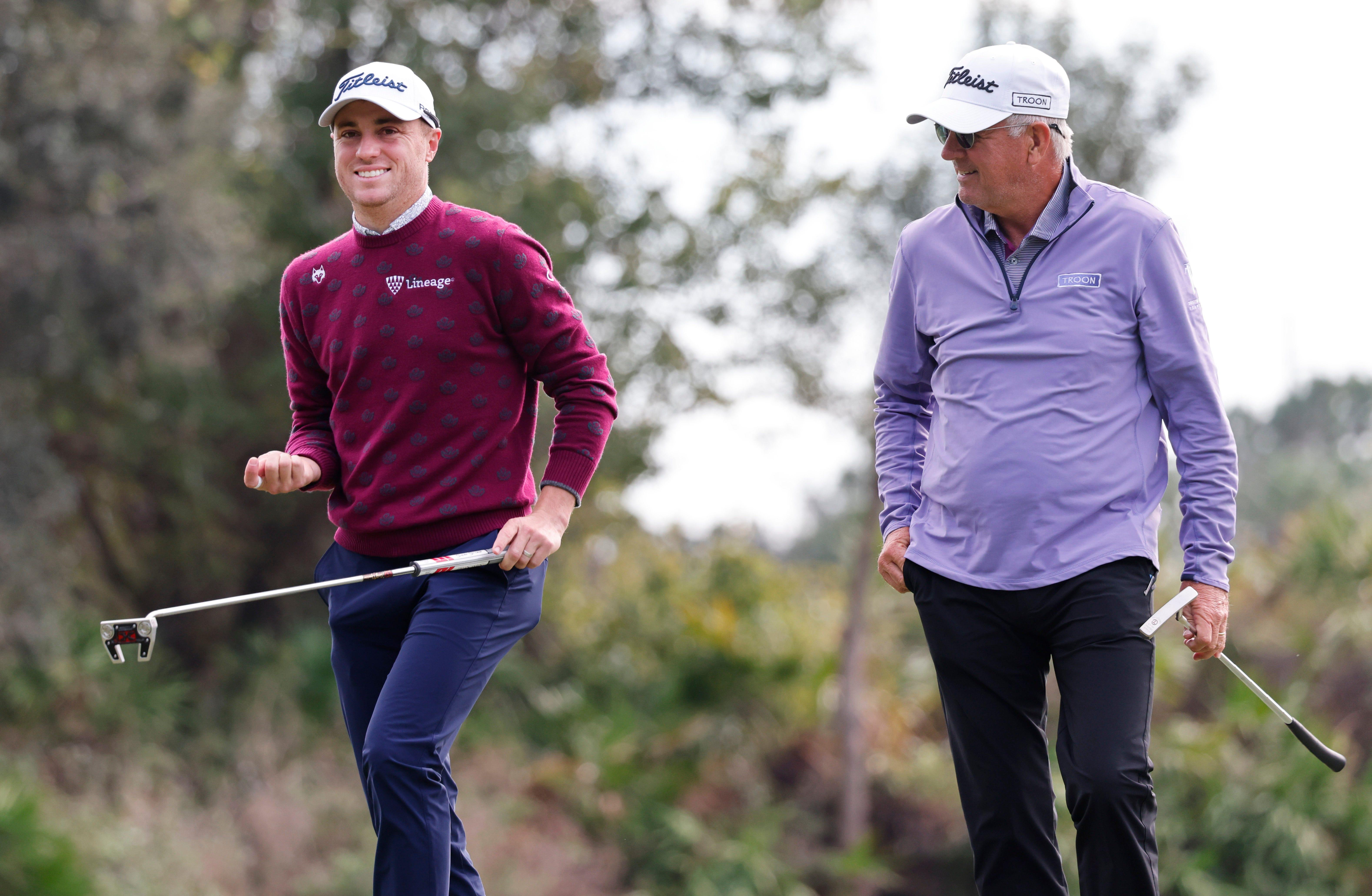 Justin Thomas (left) and his father Mike Thomas walk off of the third green during the final round of the PNC Championship golf tournament in Orlando on Dec 18, 2022.