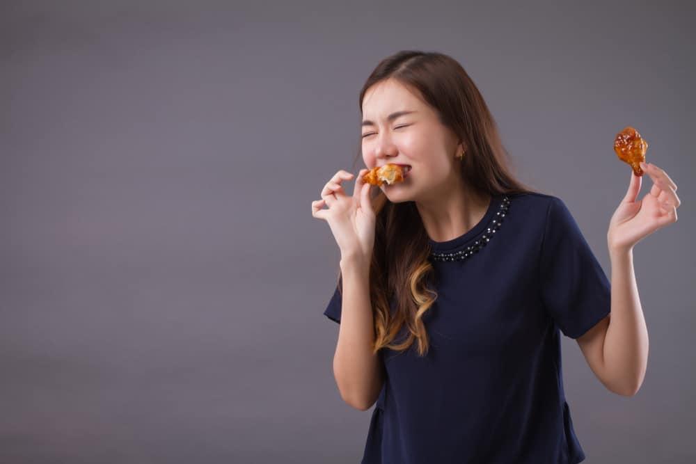 girl eating fat fried chicken