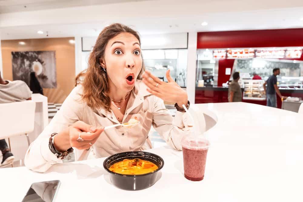 woman eating too hot and peppery soup