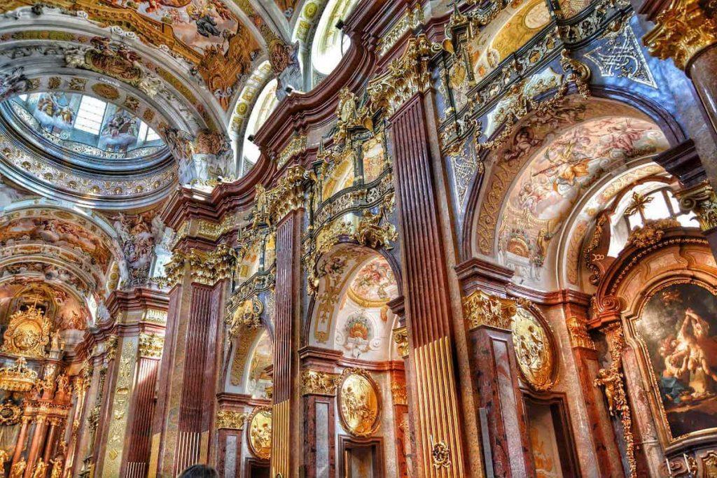 An image of a Baroque church, with ornate marble and gold leaf decorations.