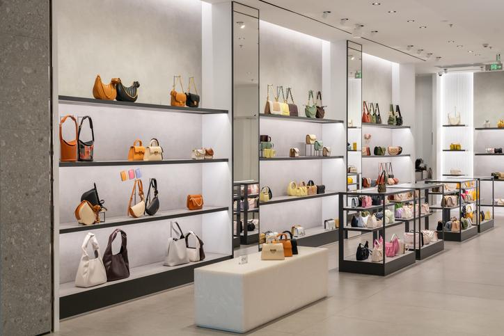 A photo of a luxury store with lots of handbags and purses