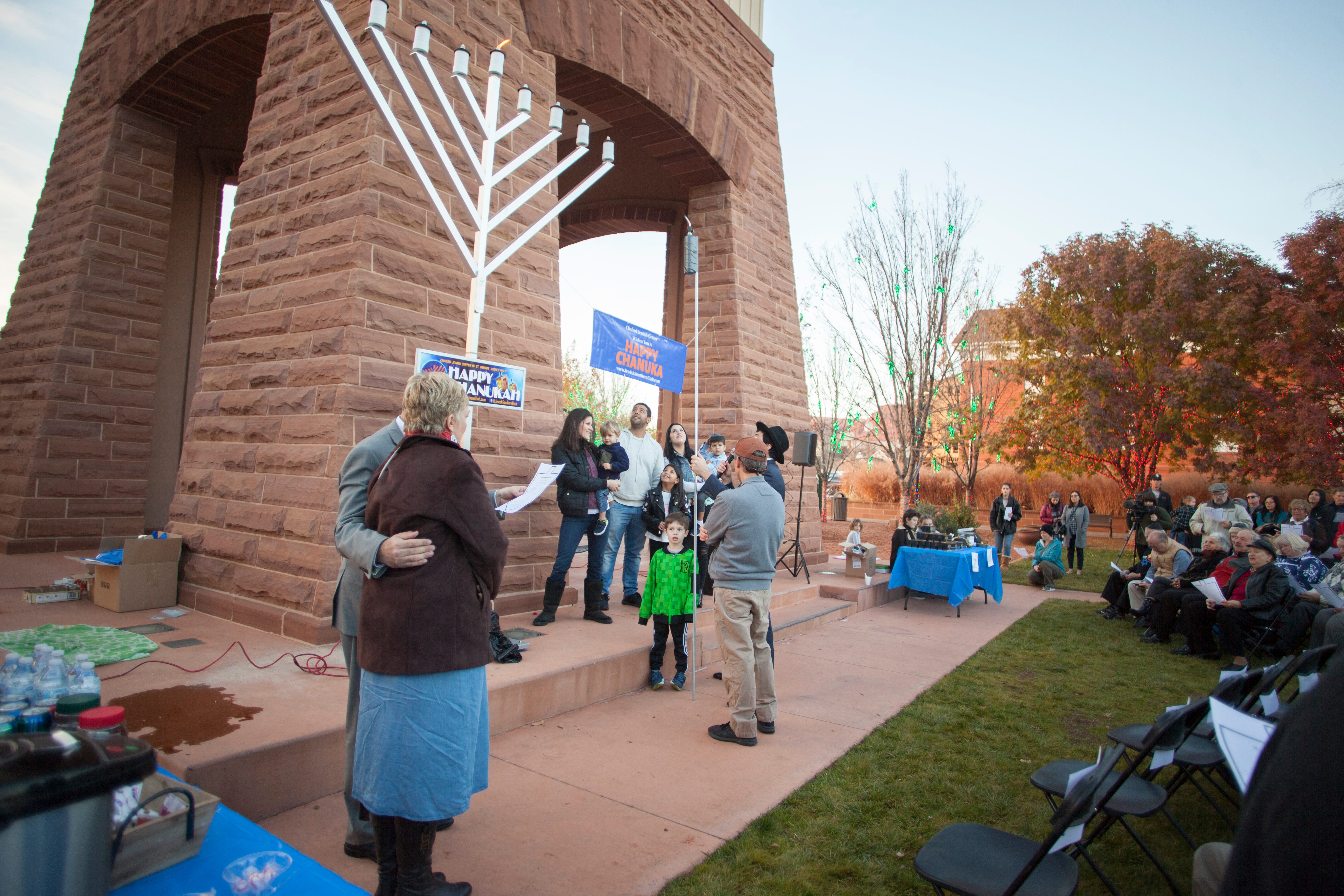 Under the direction of Rabbi Mendy Cohen members of the St. George community gather at town square to celebrate Hanukkah Sunday, Dec. 9, 2018.