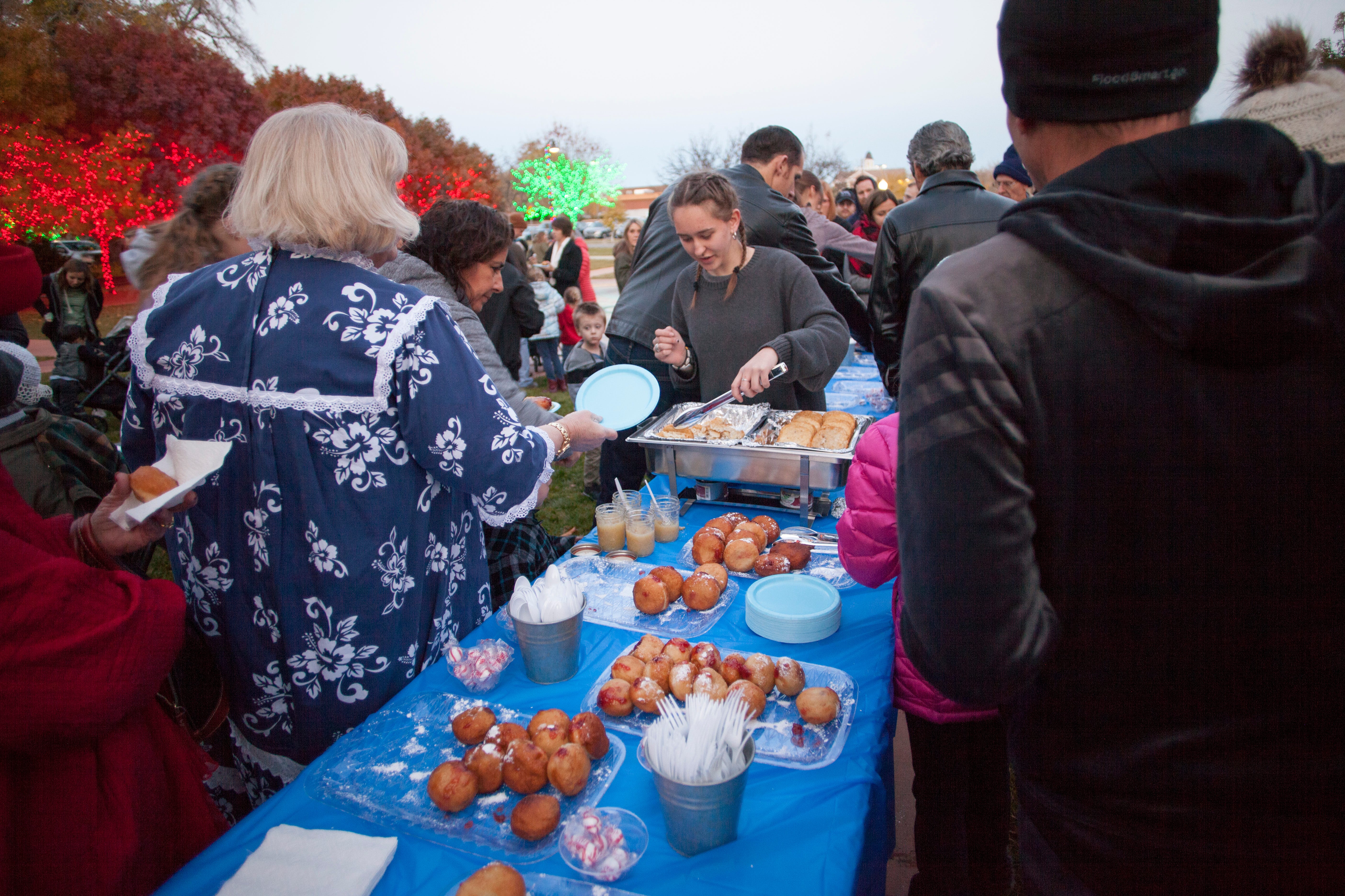 Under the direction of Rabbi Mendy Cohen members of the St. George community gather at town square to celebrate Hanukkah Sunday, Dec. 9, 2018.