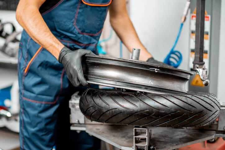 replace your motorcycle tire at Dunlop. Mechanic changing the tires