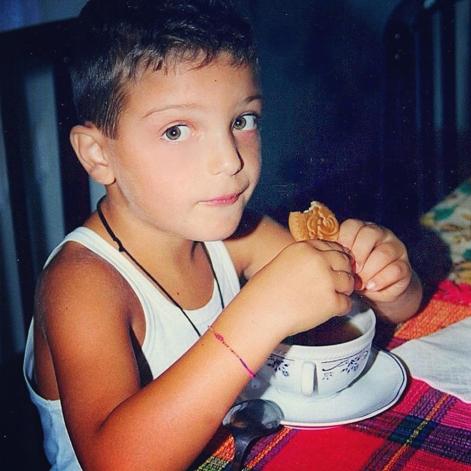 A young Gianluca eating a cookie