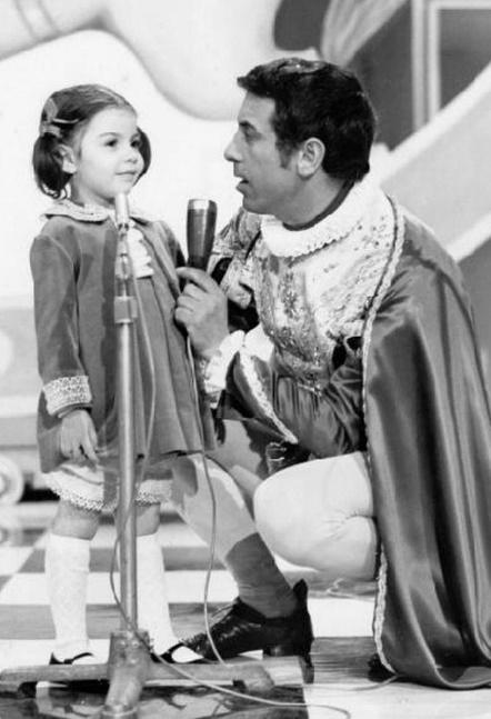 Black and white photo of Cino Tortorella talking to a little girl on the show