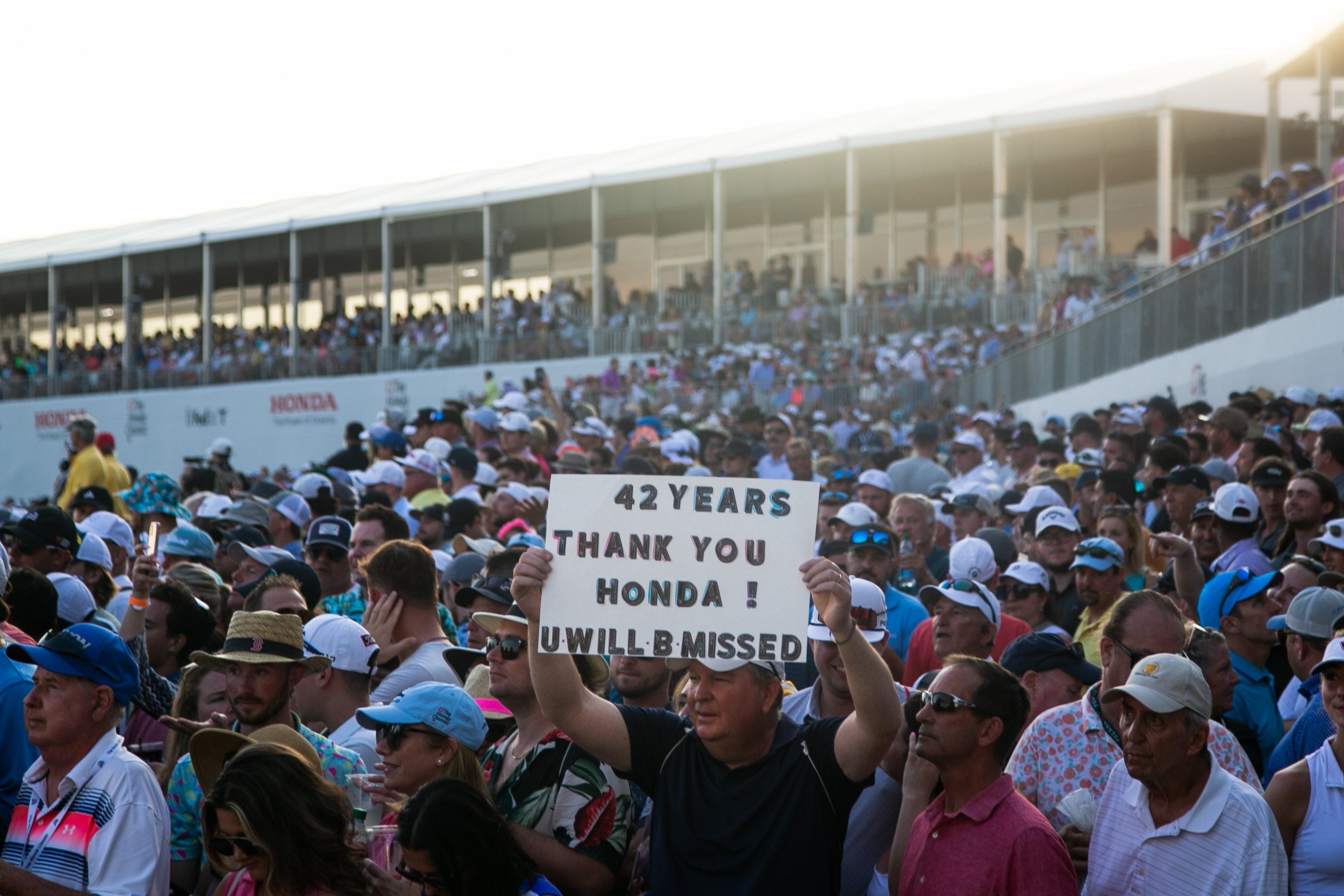 John Keiley, a part-time Jupiter resident, lifts a sign expressing gratitude for 42 years of the Honda Classic, seen during the final round of the event at PGA National on Feb. 26 in Palm Beach Gardens.