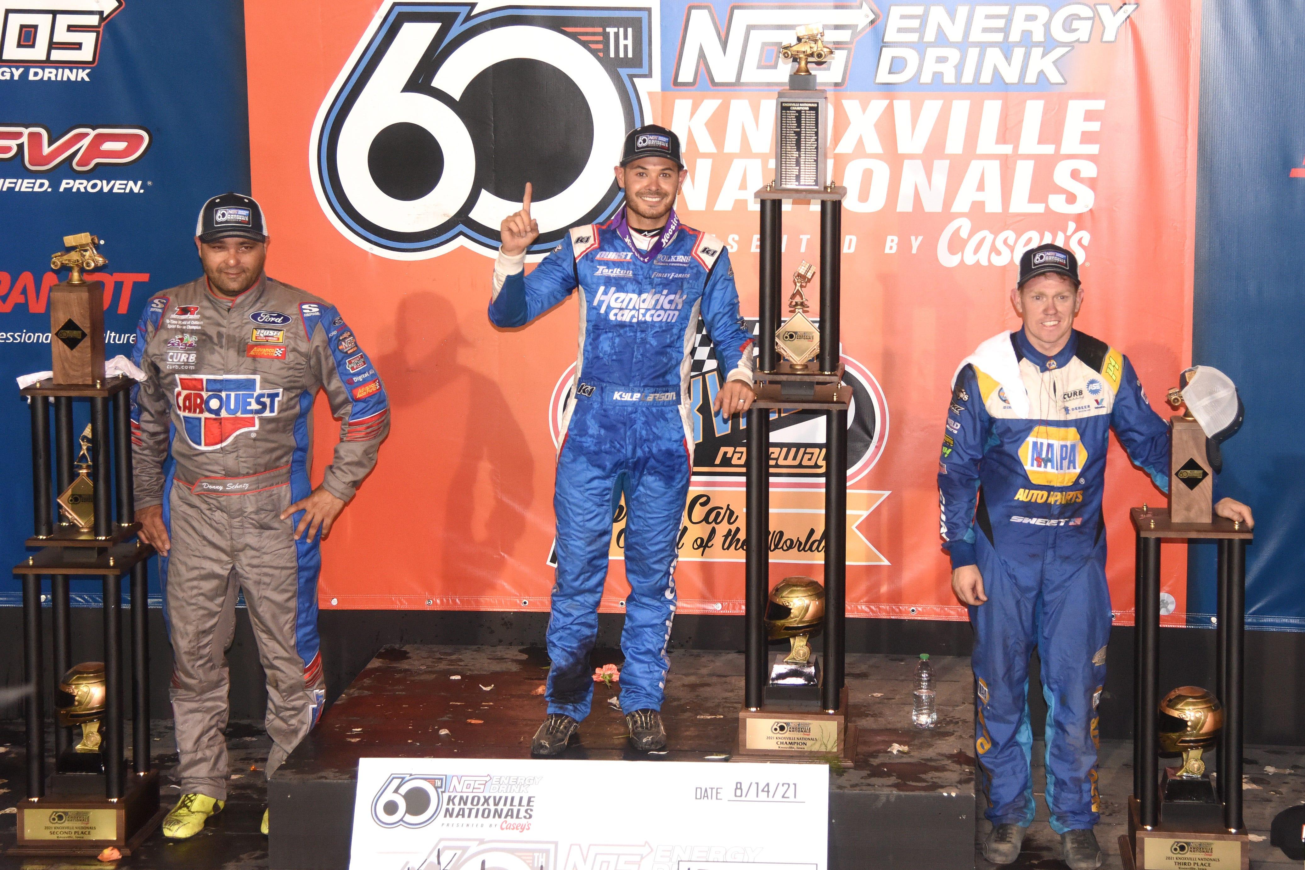 Knoxville Nationals champion Kyle Larson (center) celebrates on the podium with runner-up Donny Schatz (left) and third-place Brad Sweet Saturday at Knoxville Raceway.