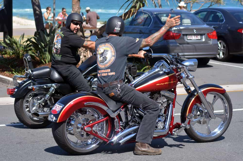 Men ride Harley-Davidson motorcycle