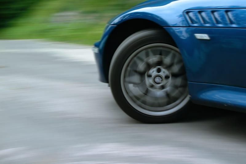 Blue sports car turning with the tires squeaking