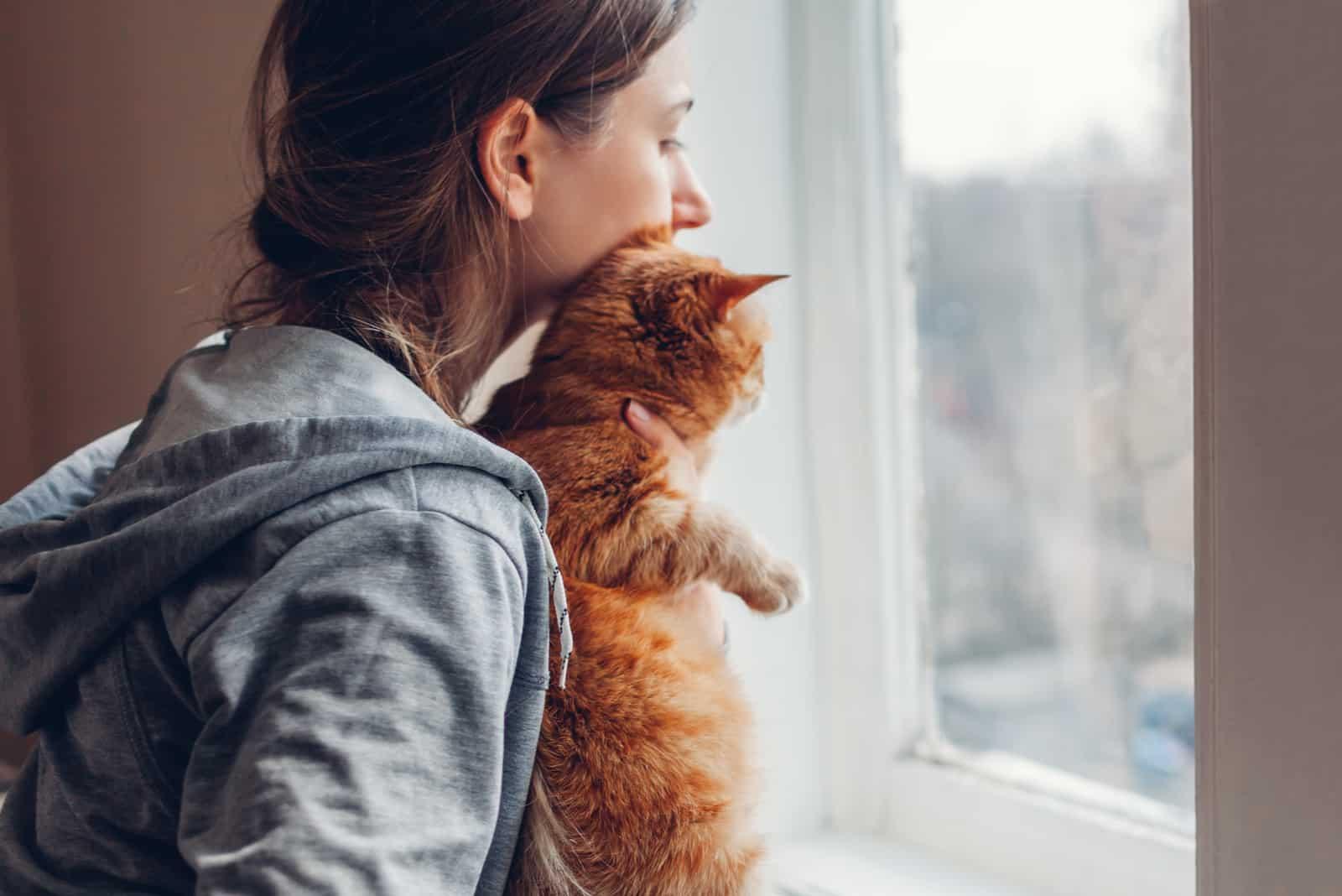 sad woman cuddling her cat