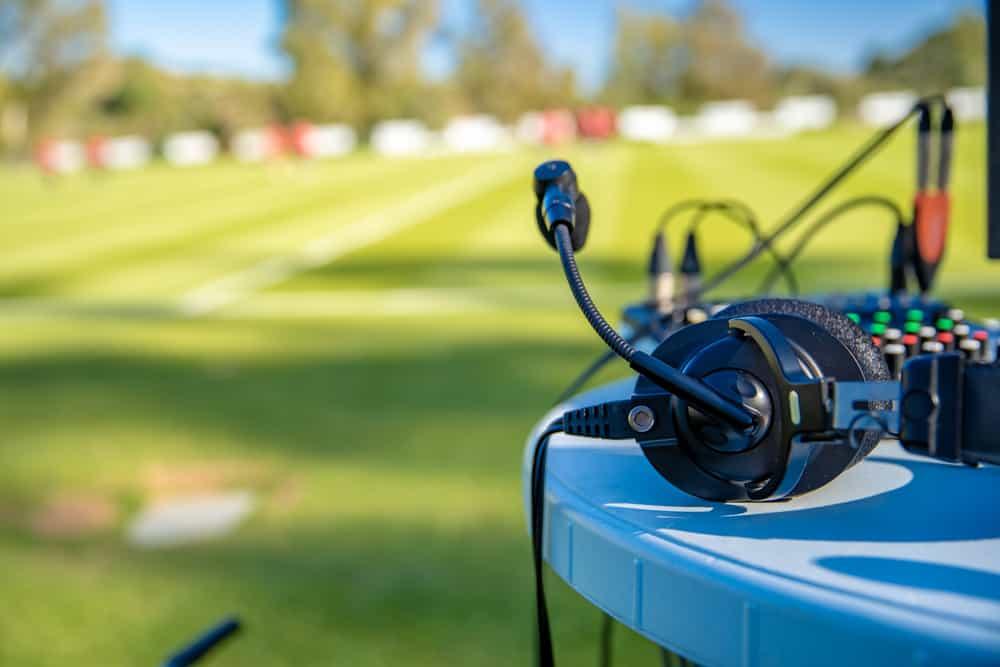 commentator headsets on the table next to the football field. stream for television and radio