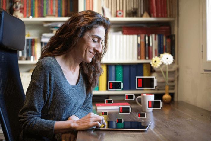 Woman using an iPad with a draining iPad battery