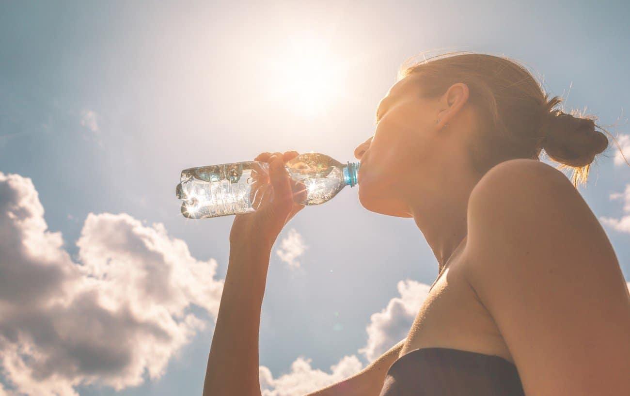 A woman drinking water.