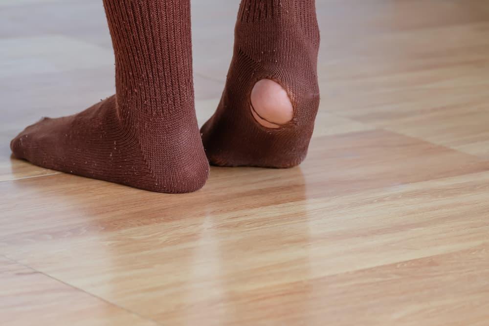 worn out socks with a hole or torn