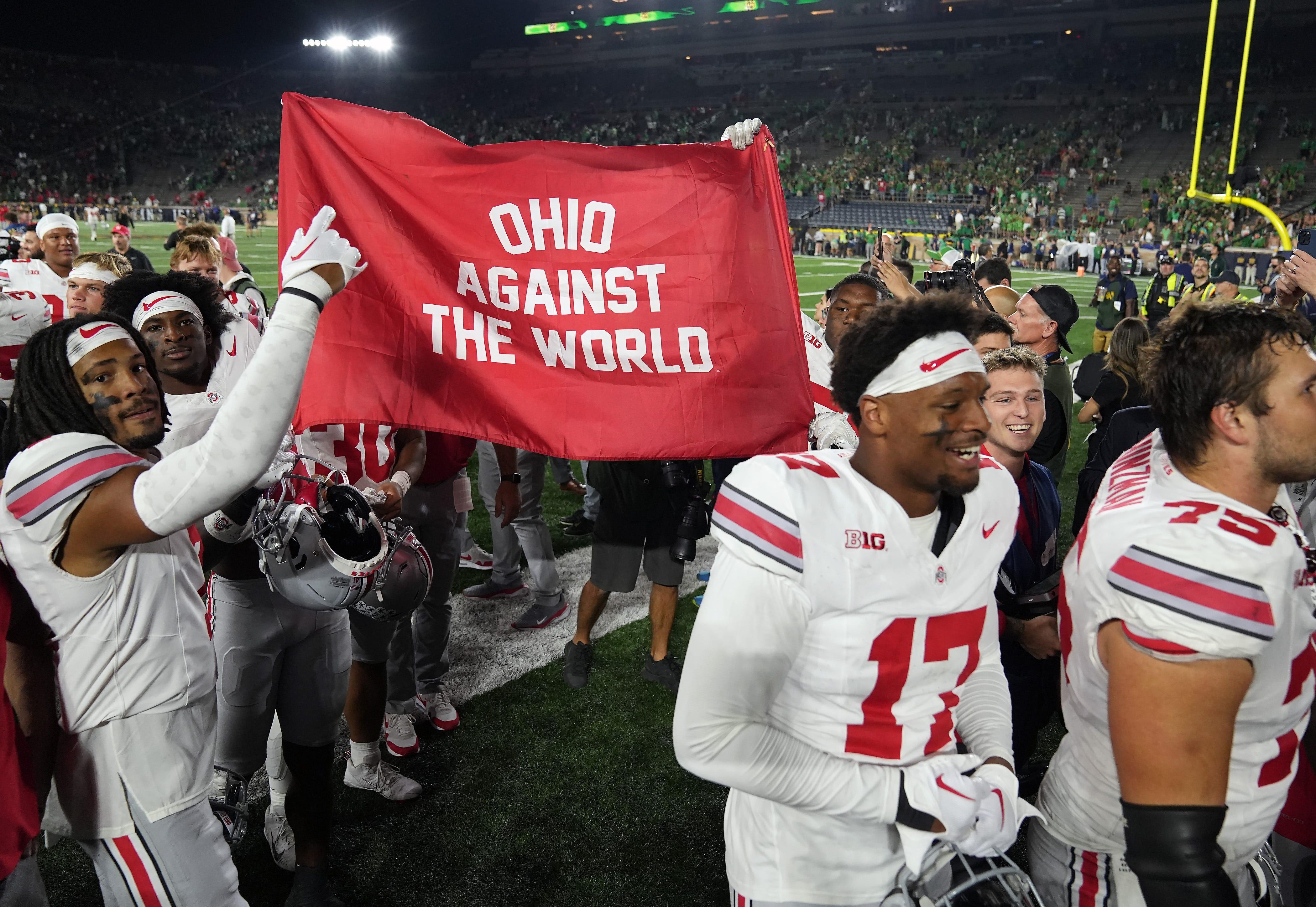 Ohio State players celebrate as they leave the field after beating Notre Dame.