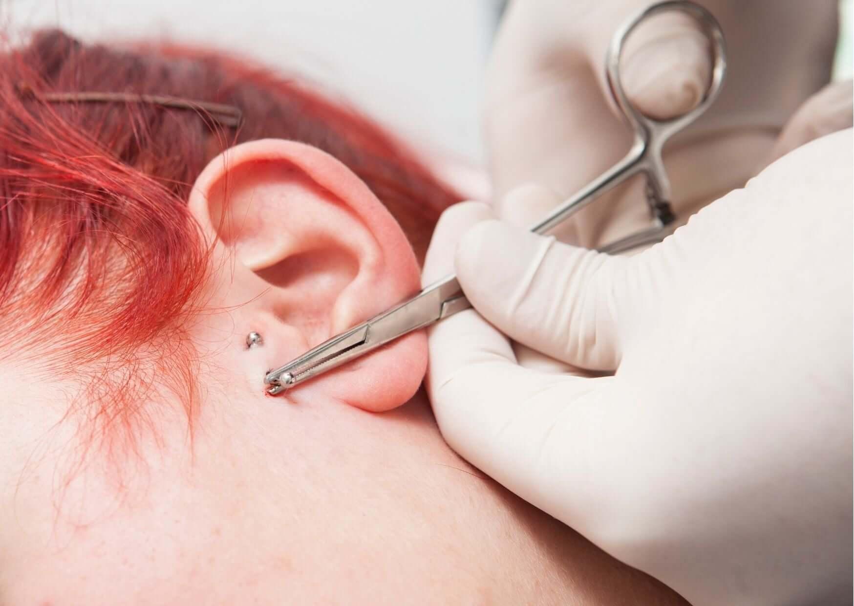client-getting-ears-pierced-in-a-studio
