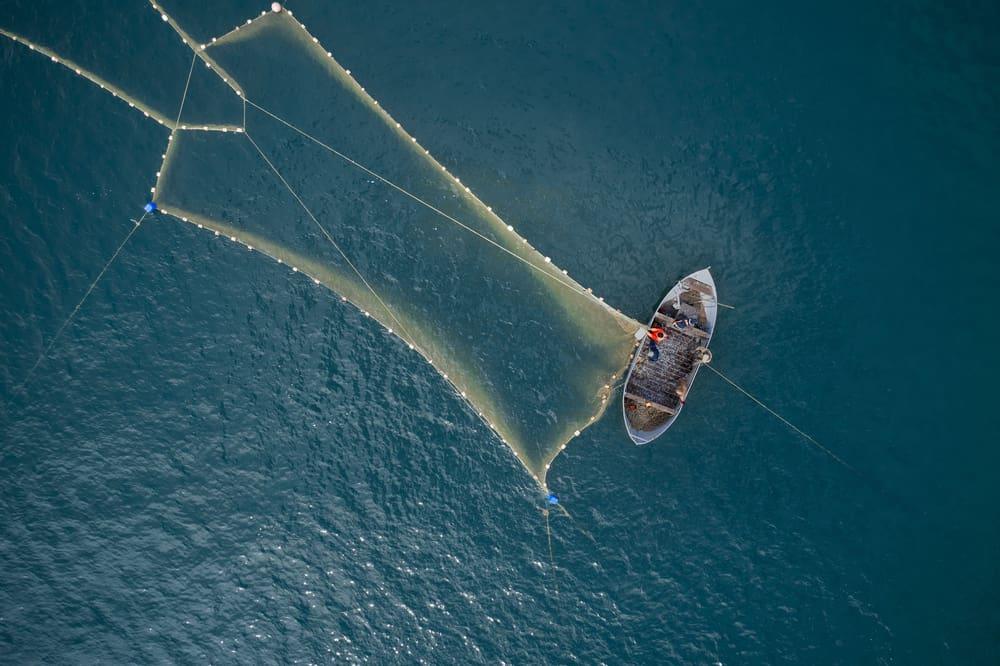 Vintage wooden boat in coral sea