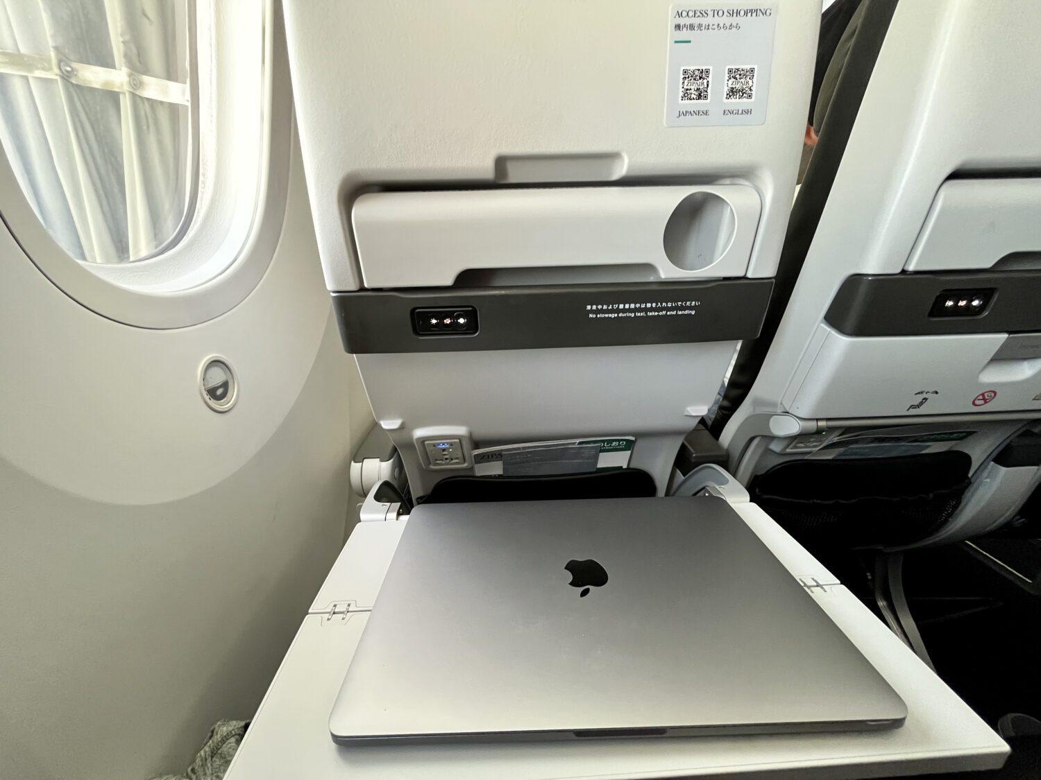 Zipair economy tray table with laptop