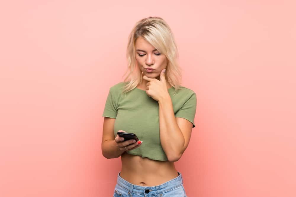 thinking woman while using phone