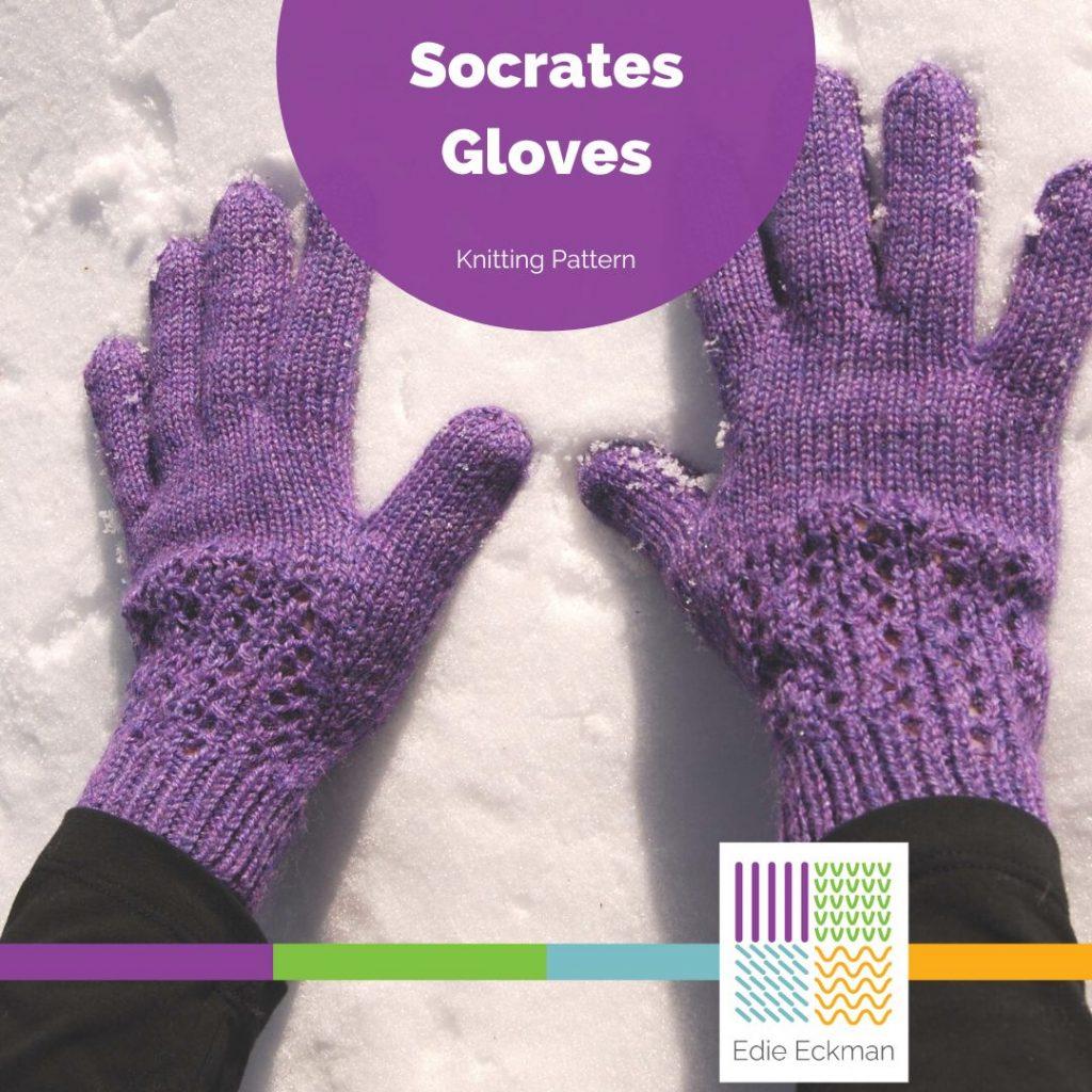 hands on snow, wearing purple, lacy-cuffed Socrates knitted gloves