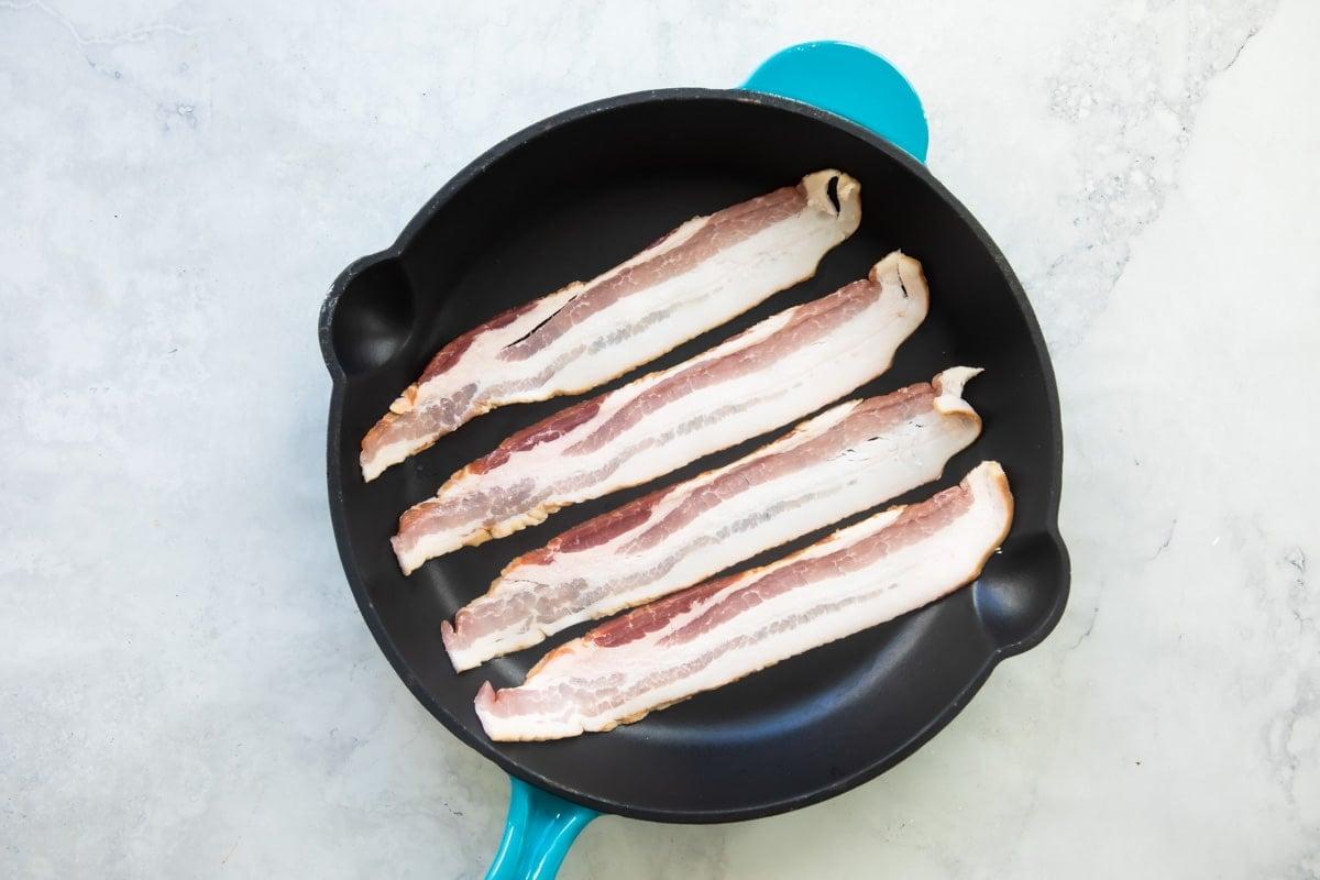 Cooking bacon in a skillet.