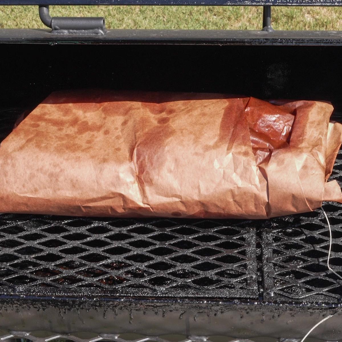 Brisket wrapped in peach butcher paper.