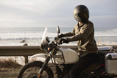 MOTORCYCLIST WITH SEA IN BACKGROUND