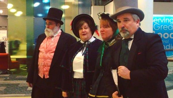 The Dickens Carolers (from left) Dan Shockley, Karen Hall, Jennifer Nicholson and Michael Davidson visited the IndyStar while caroling Downtown.