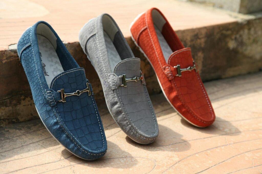 three unpaired red gray and blue horsebit loafers