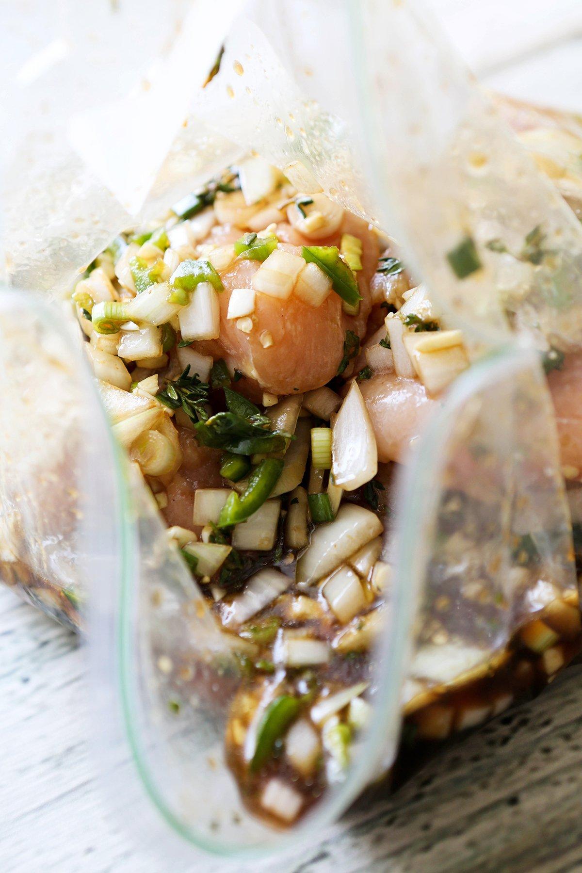 Chicken and marinade in a plastic bag.