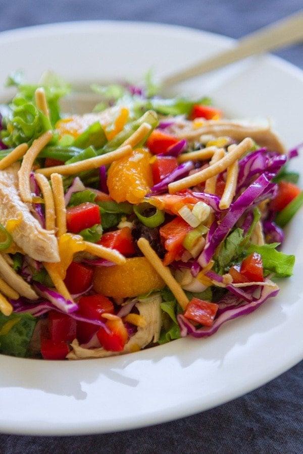 chinese asian slaw in bowl with tongs