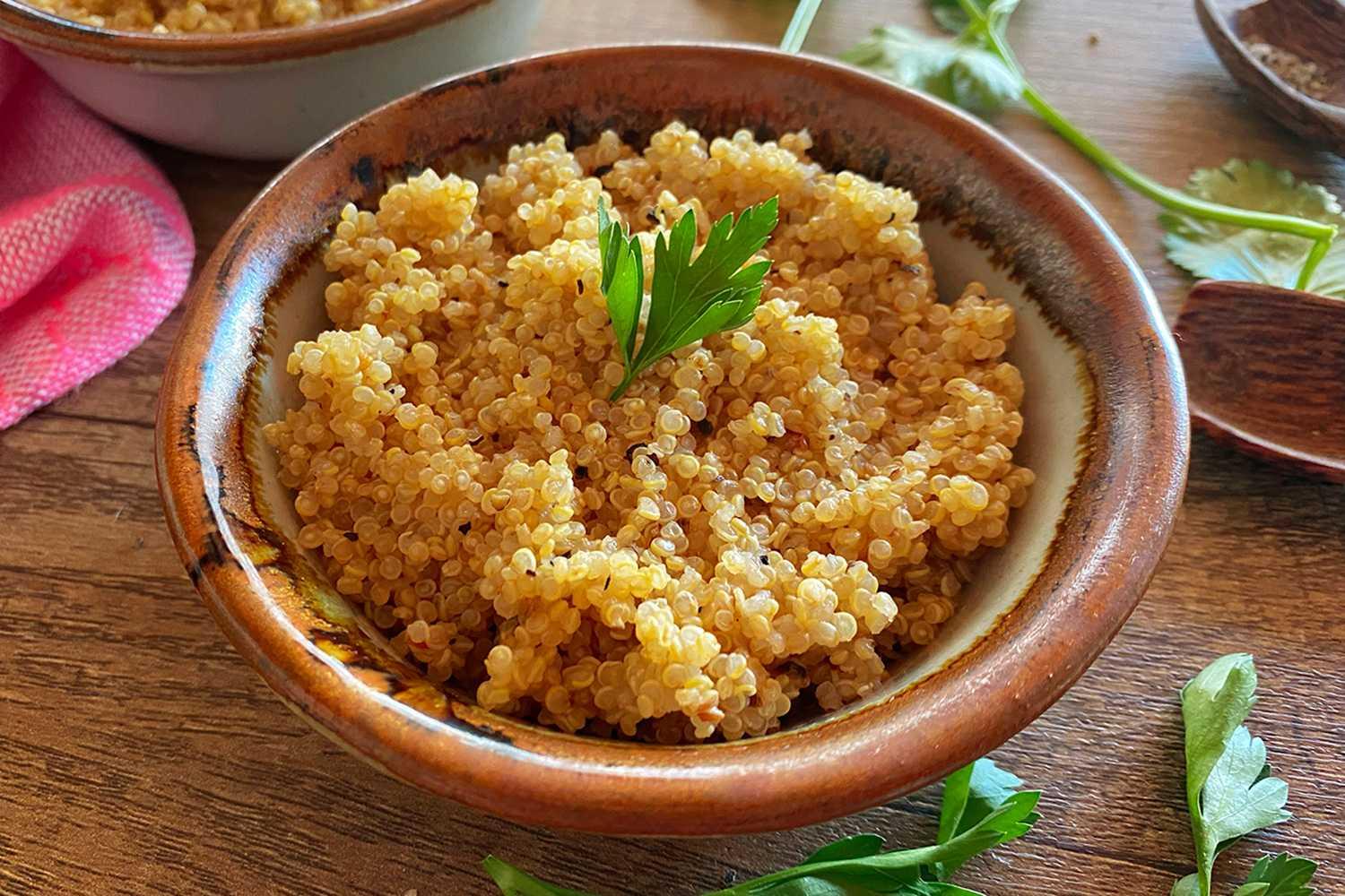 cooked quinoa in a brown ball topped with parsley