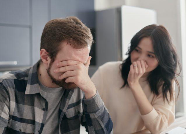 caucasian male putting his face in his hand because he is stressed about paying medical bills