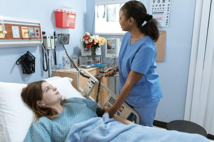 african american nurse checking a patient