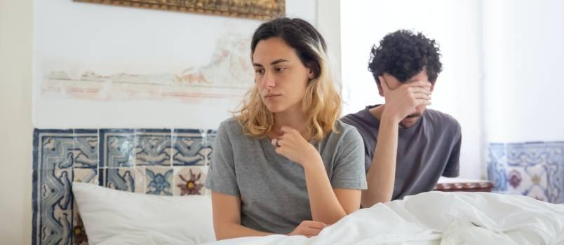 Depressed couple sitting in bed