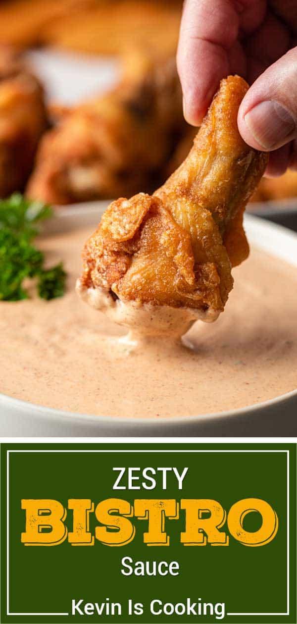 Dipping a chicken wing into Zesty Bistro Sauce
