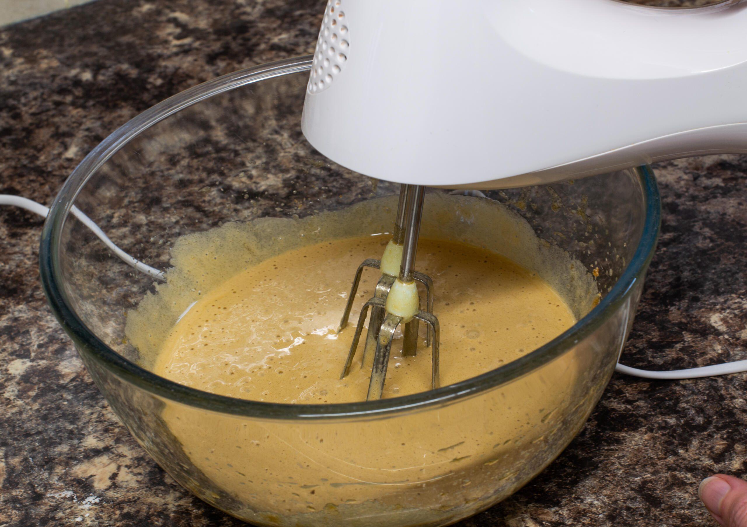 Folding walnuts and white chocolate into blondie batter