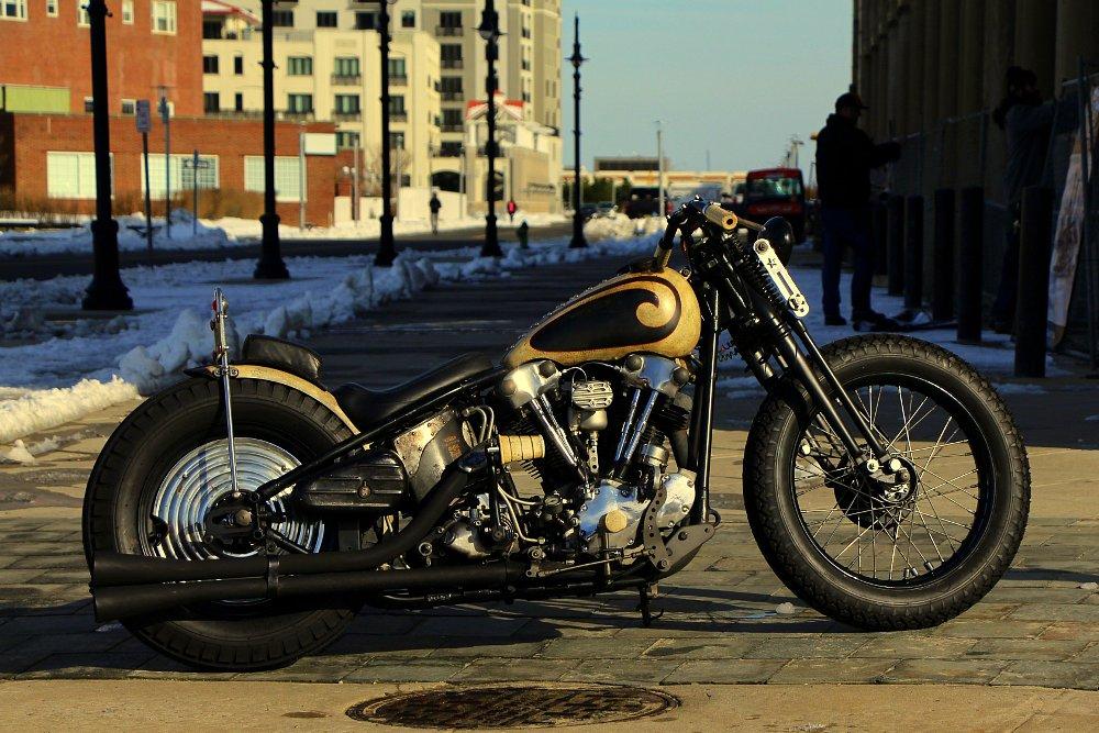 A custom motorcycle with a sissy bar.