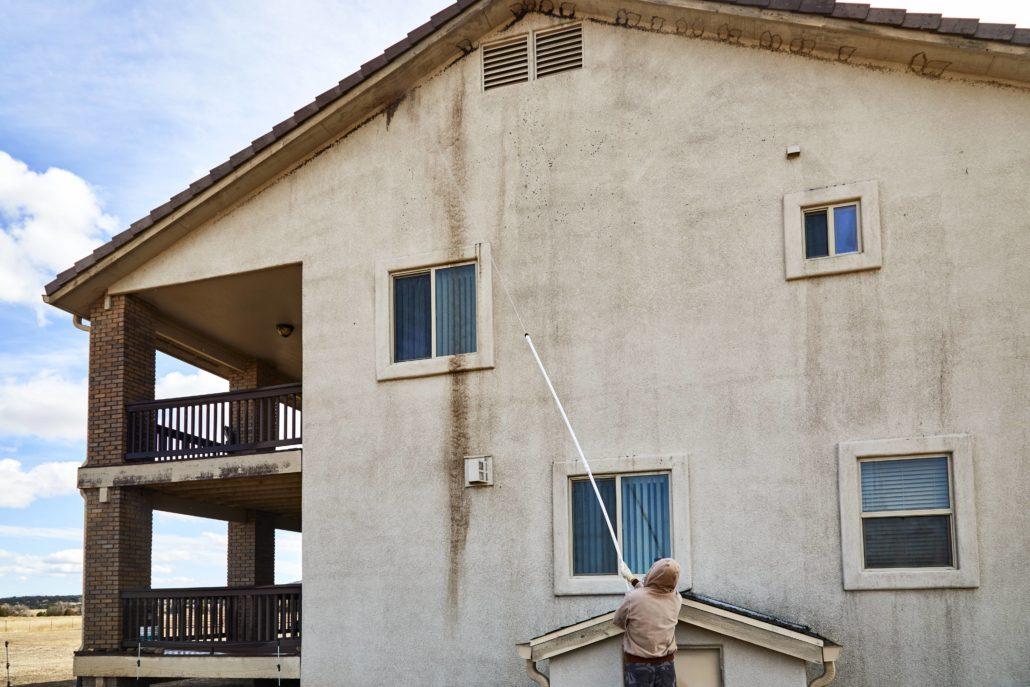 cleaning stucco on a house