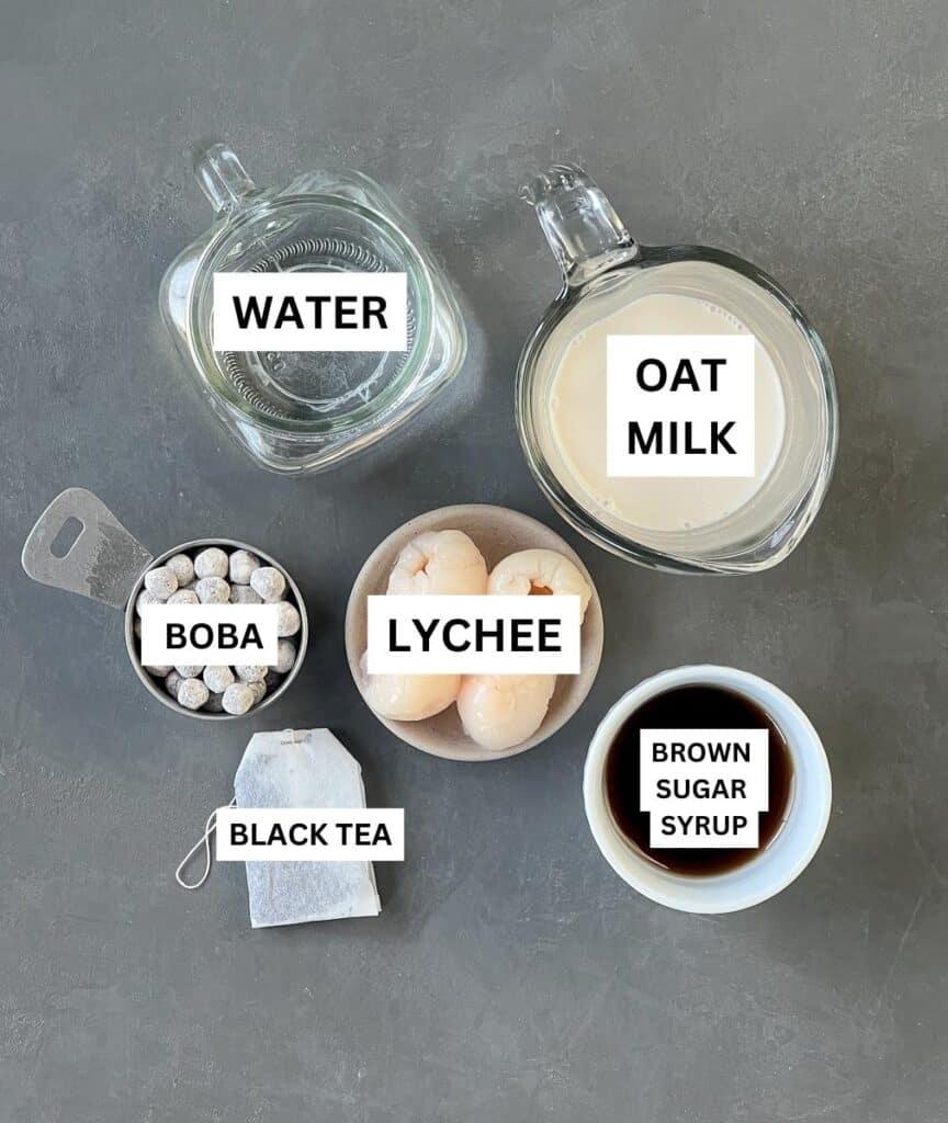 Lychee bubble tea ingredients laid out individually with labels.