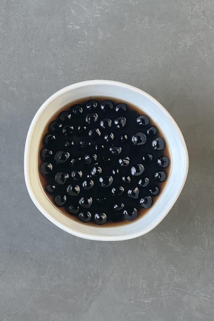 A bowl of boba pearls in brown sugar syrup.