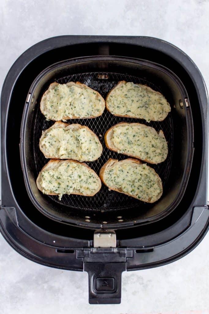 Overhead view of garlic bread on a plate.