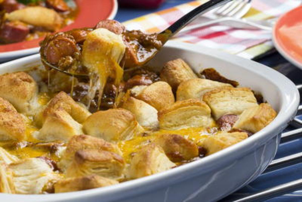 Juicy chili dog bubble bake in a white casserole.