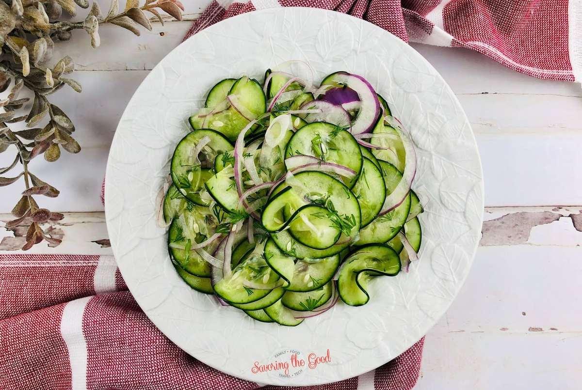 horizontal image Cucumber Onion Salad Recipe on a white plate