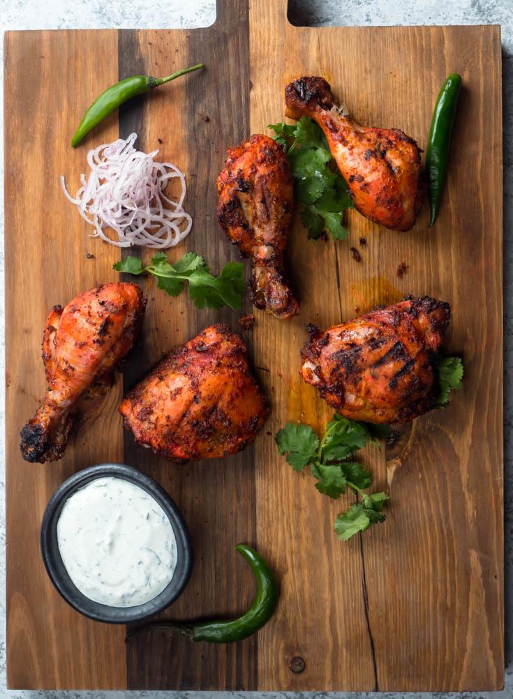 Tandoori chicken on a board from above.