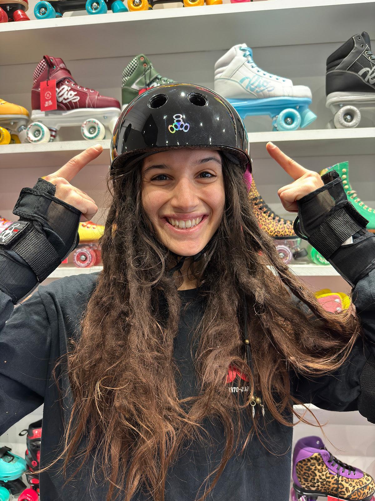 roller skater pointing to helmet