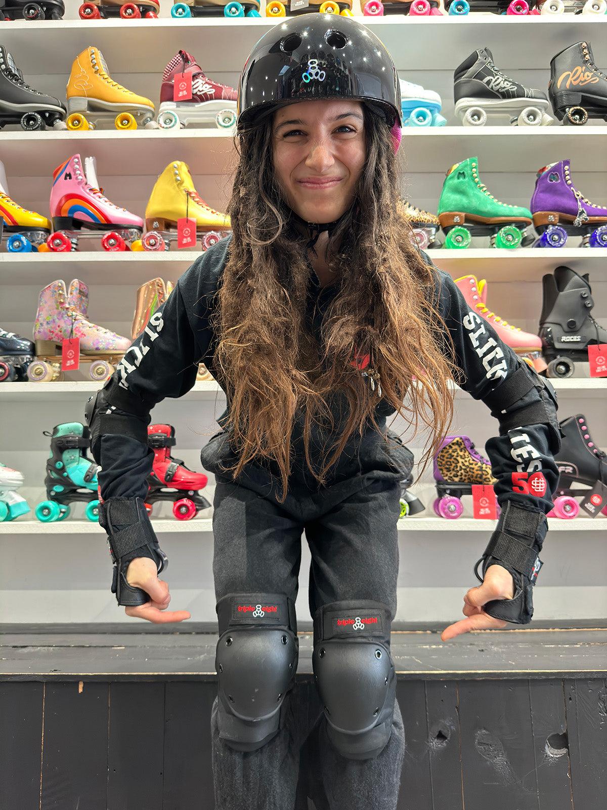 roller skater pointing to knee pads